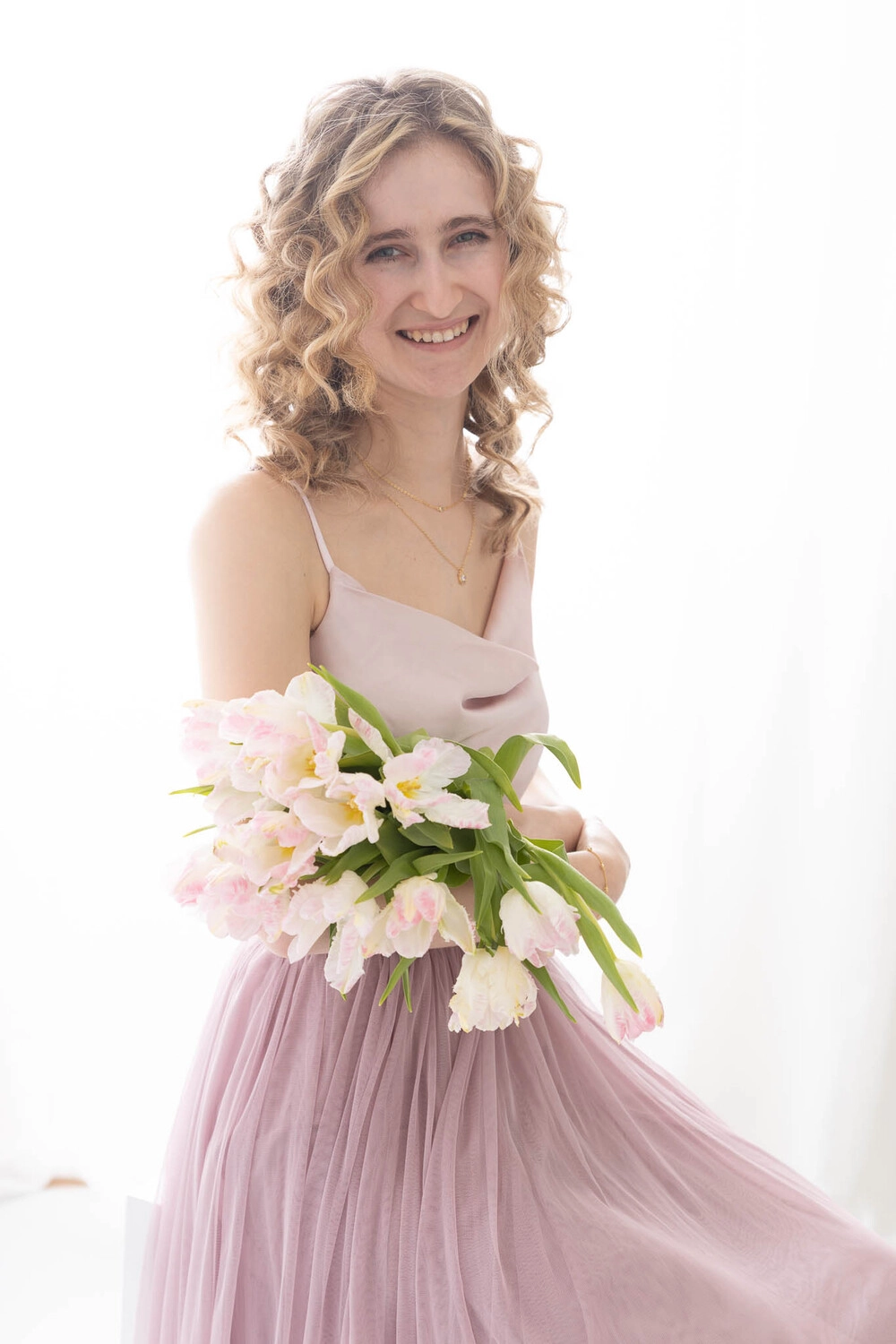 Ein Portrait von Jasmin während sie einen Blumenstrauß in der Hand hält